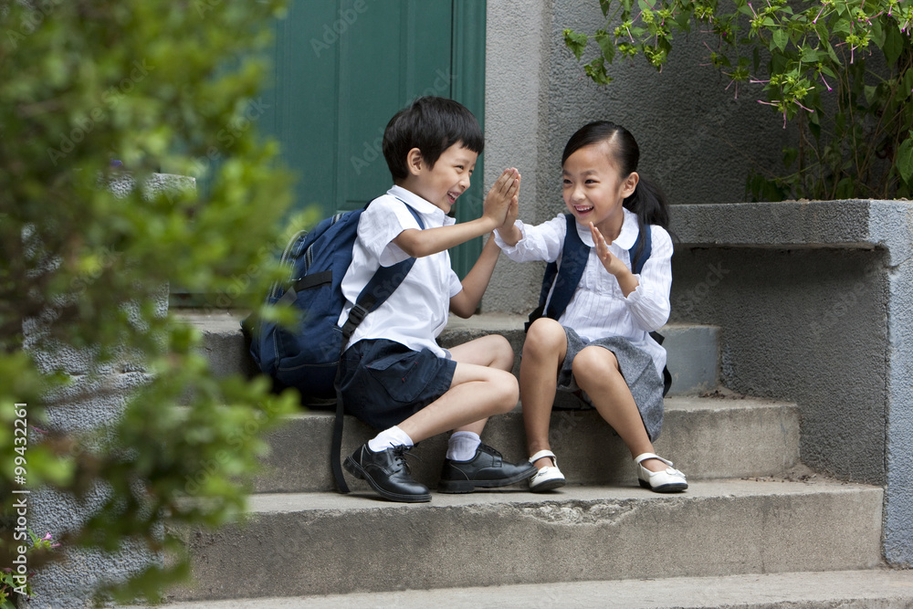 Fototapeta premium Two school children playing outside