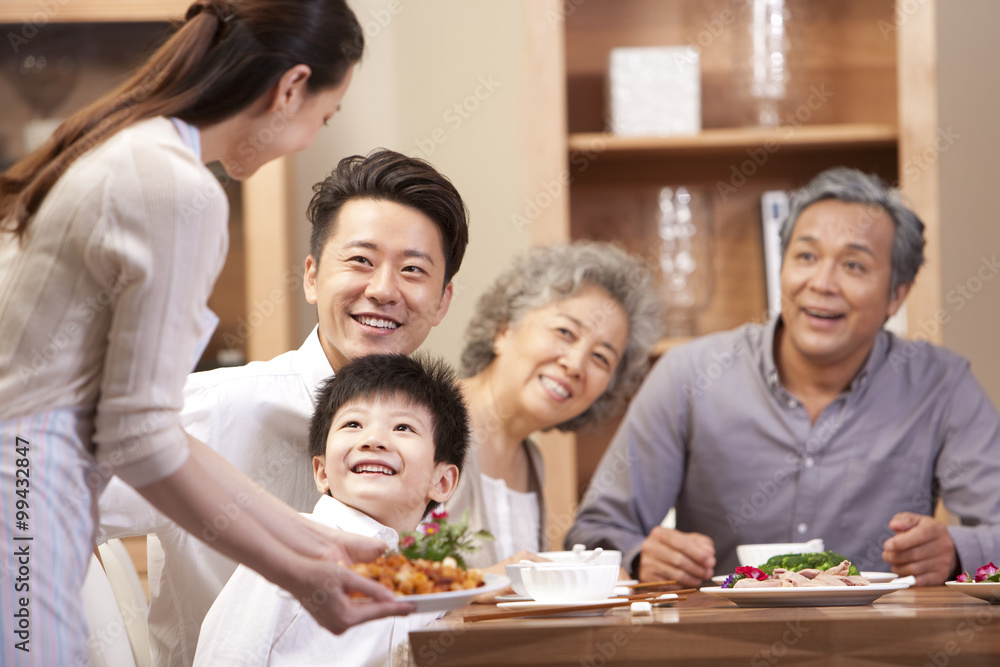 Young woman serving Chinese food for the whole family