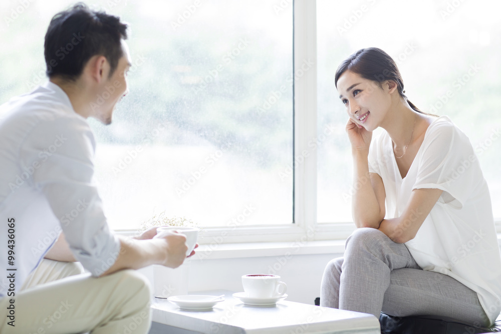 Happy young couple drinking coffee in coffee shop Happy young couple drinking coffee in coffee shop