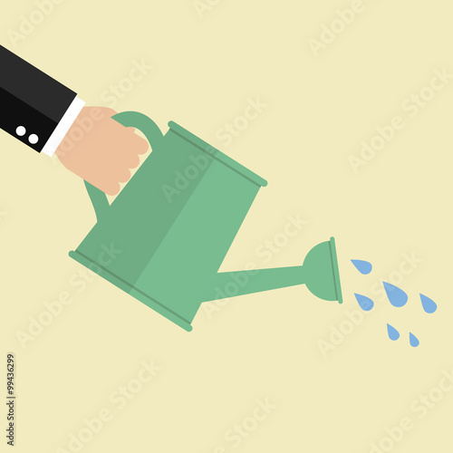 Hand holding watering can