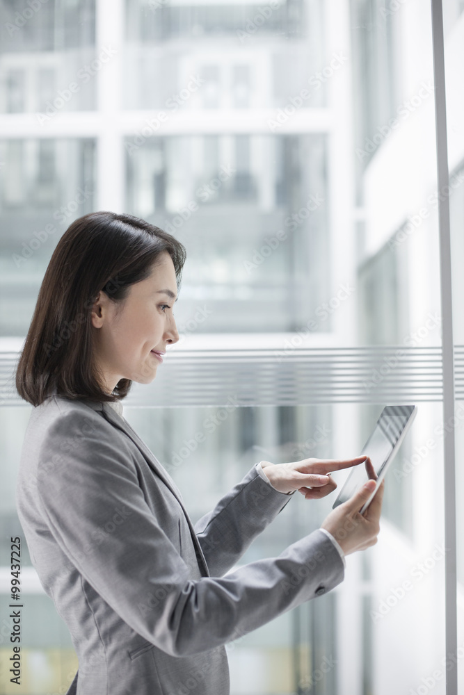 Young businesswoman using digital tablet Young businesswoman using digital tablet