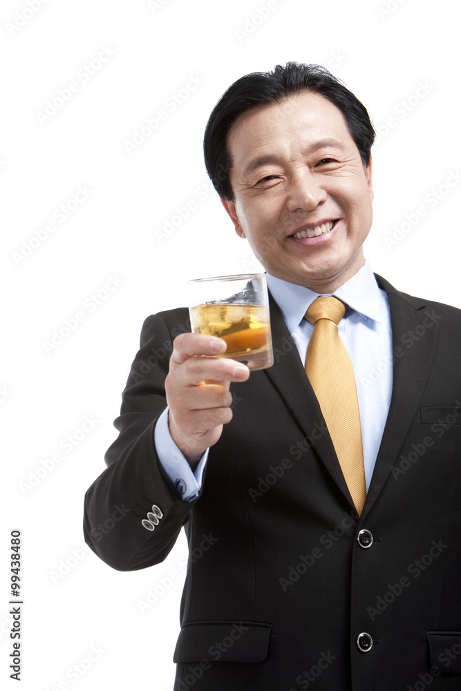 Senior businessman holding a glass of whiskey Senior businessman holding a glass of whiskey