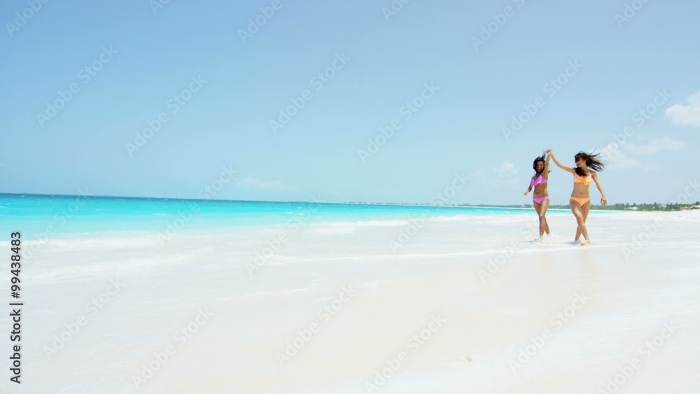 Multi ethnic girlfriends wearing tropical beach swimwear Multi ethnic girlfriends wearing tropical beach swimwear