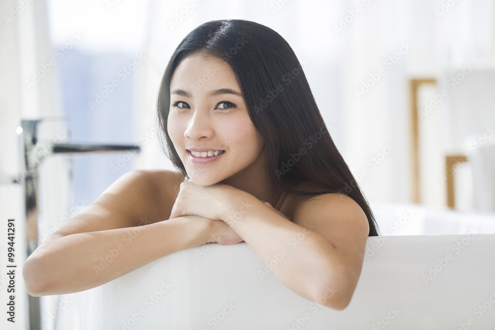 Portrait of beautiful young woman relaxing in bathtub Portrait of beautiful young woman relaxing in bathtub