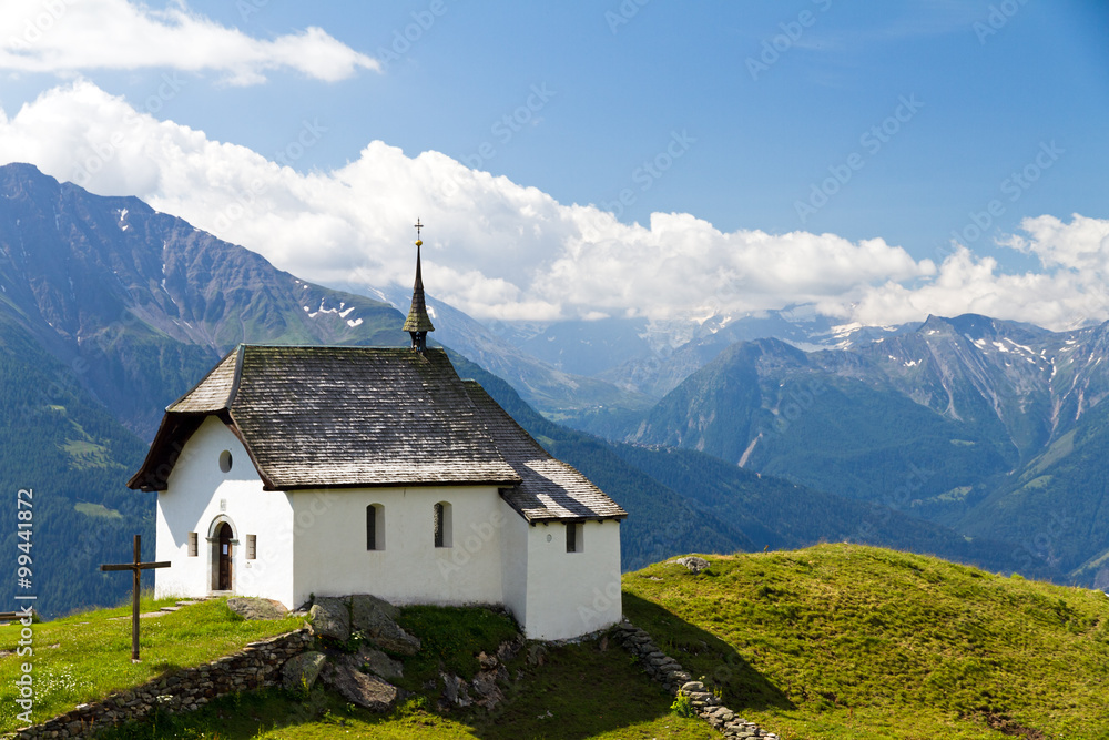 Little church in the mountains of the Swiss alps on a beautiful day