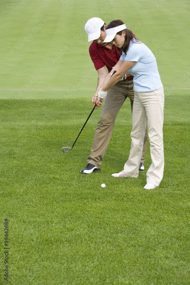 Fototapeta premium Golf coach teaching playing golf