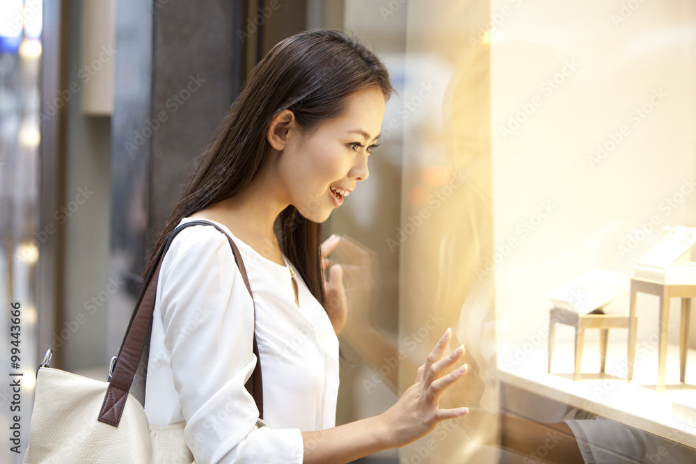 Beautiful young woman doing window shopping in Hong Kong Beautiful young woman doing window shopping in Hong Kong