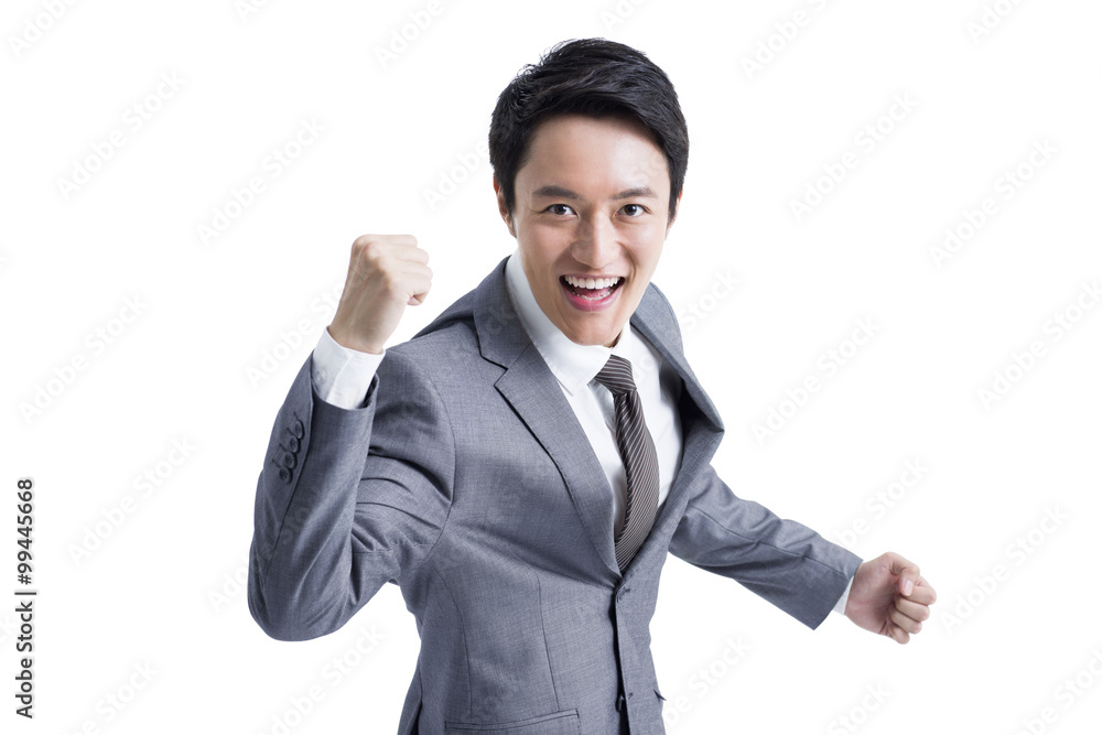 Excited businessman punching the air Excited businessman punching the air
