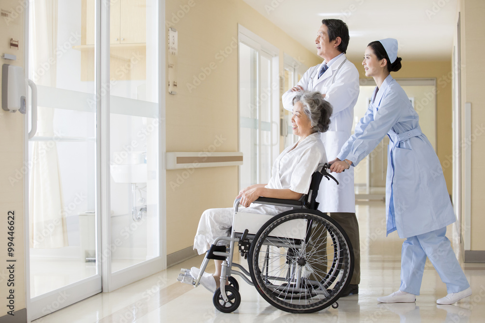 Medical workers taking care of senior woman in wheel chair Medical workers taking care of senior woman in wheel chair