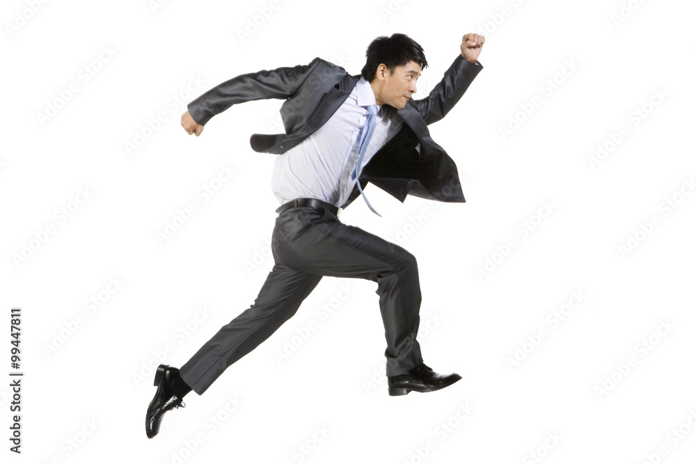 Young businessman running fast
