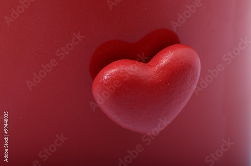 Red heart on red background