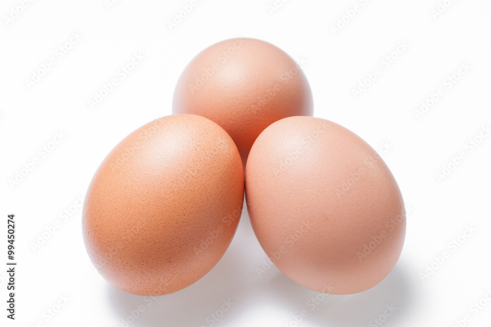 Three brown chicken egg on white background