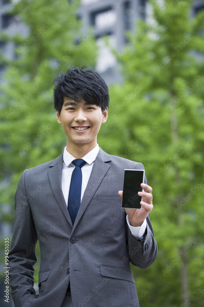 Portrait of young businessman with mobile phone Portrait of young businessman with mobile phone