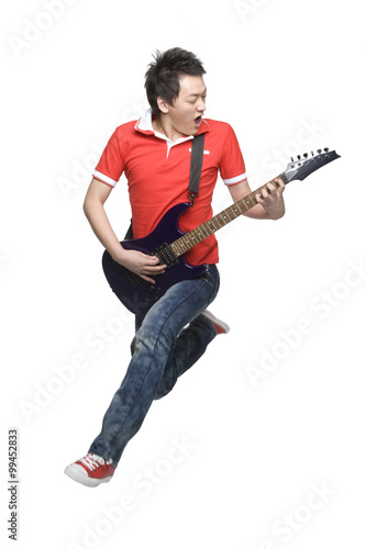 Young man playing an electric guitar