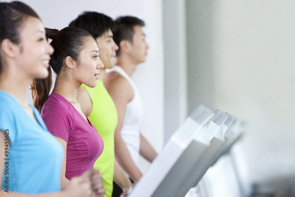 Four People Running on Treadmills Four People Running on Treadmills