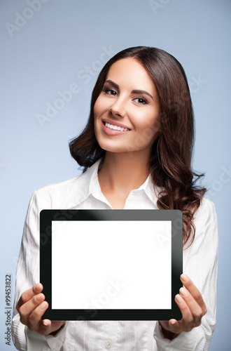 Business woman showing blank tablet pc, on grey