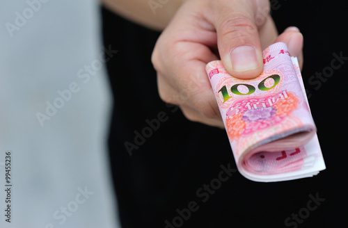 Hand with chinese yuan money photo