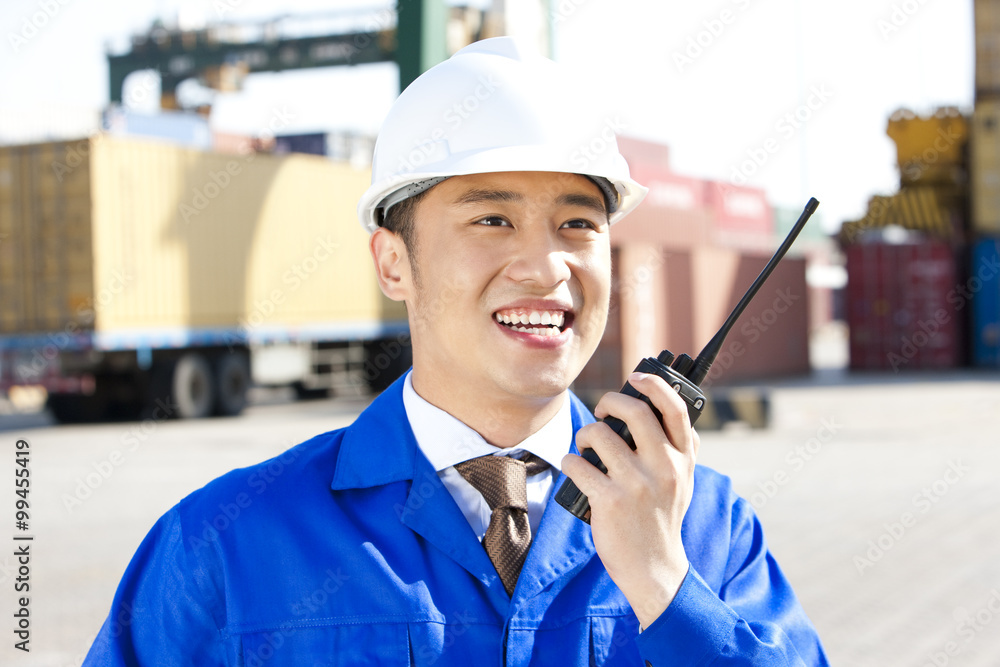 shipping industry manager with a walkie-talkie shipping industry manager with a walkie-talkie