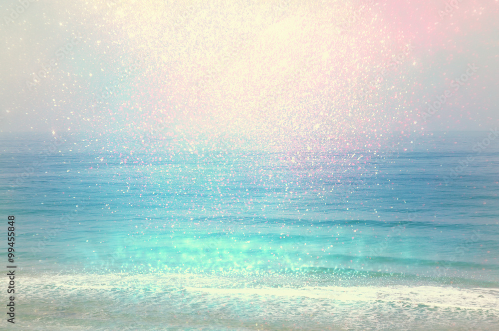 Obraz premium background of blurred beach and sea waves with bokeh lights, vintage filter. 