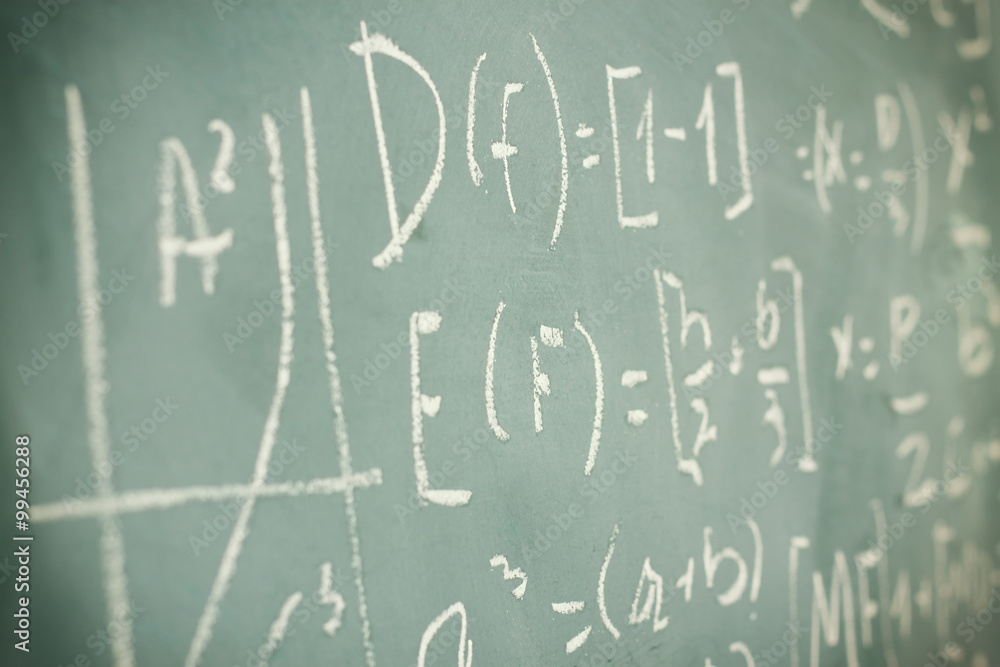 side view of math formulas and calculation written over chalkboard. selective focus.
side view of math formulas and calculation written over chalkboard. selective focus.