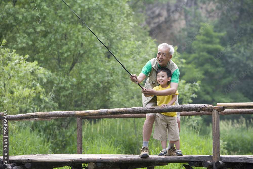 Grandfather and grandson fishing Grandfather and grandson fishing