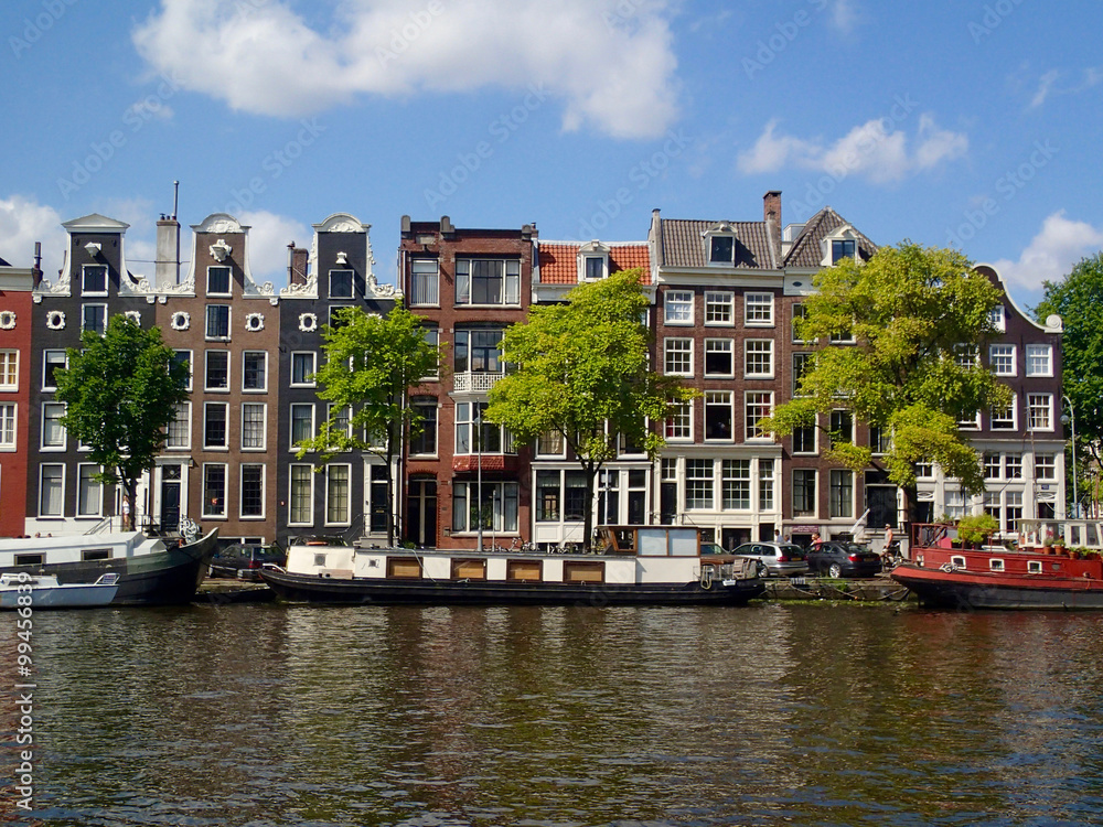 View from Amstel, Amsterdam canal, towards dutch houses