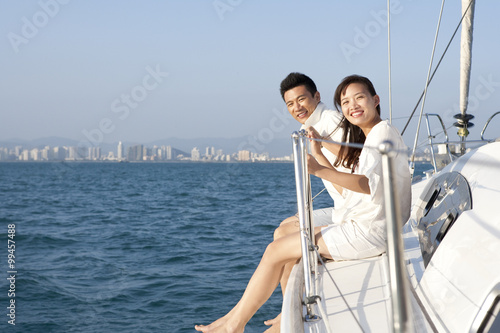 Young couple sitting on the deck © Blue Jean Images
