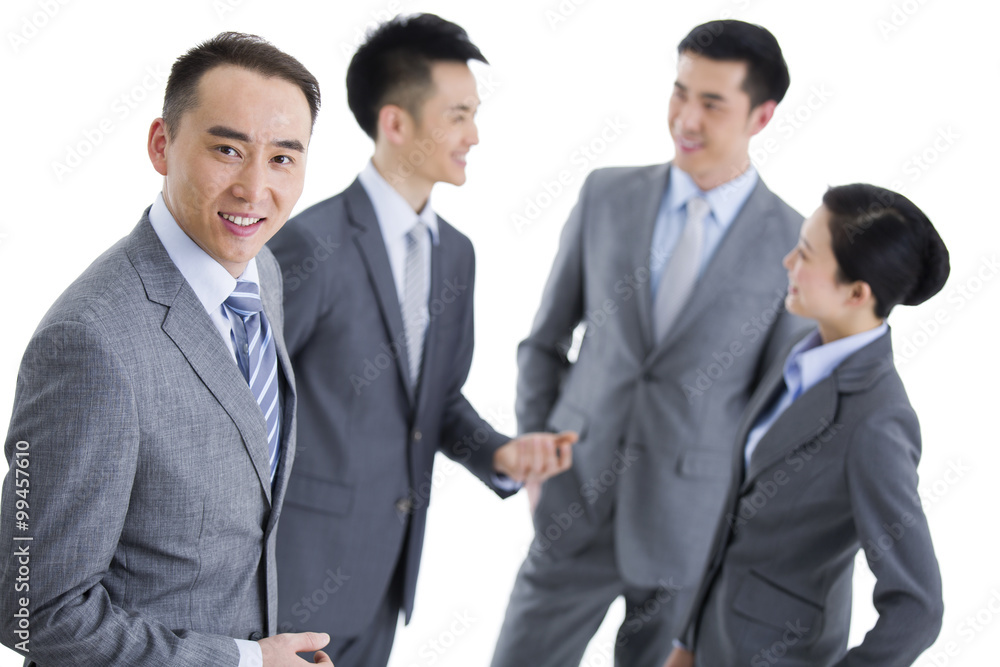 Businessman with team in background Businessman with team in background
