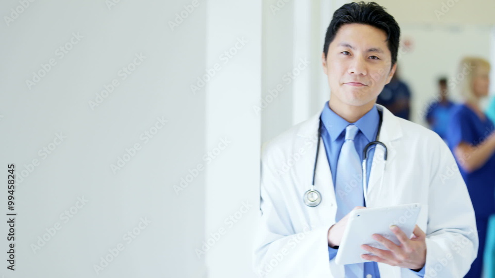 Portrait of Asian American male doctor working on technology in medical center Portrait of Asian American male doctor working on technology in medical center