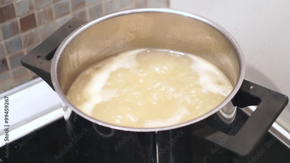 Boiling pasta in pot at ceramic stove Boiling pasta in pot at ceramic stove