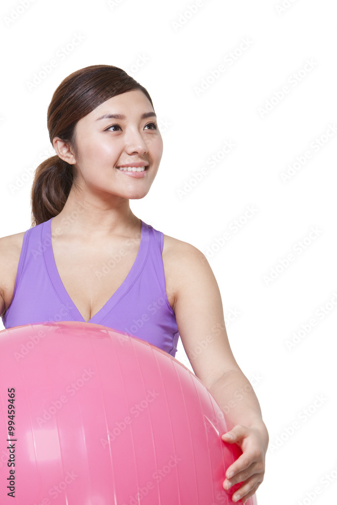 Young woman holding fitness ball Young woman holding fitness ball