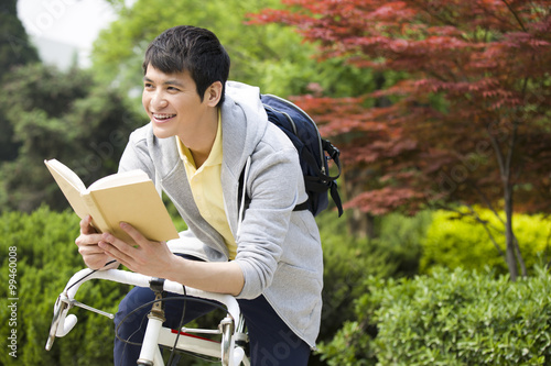 Male college student reading a book photo