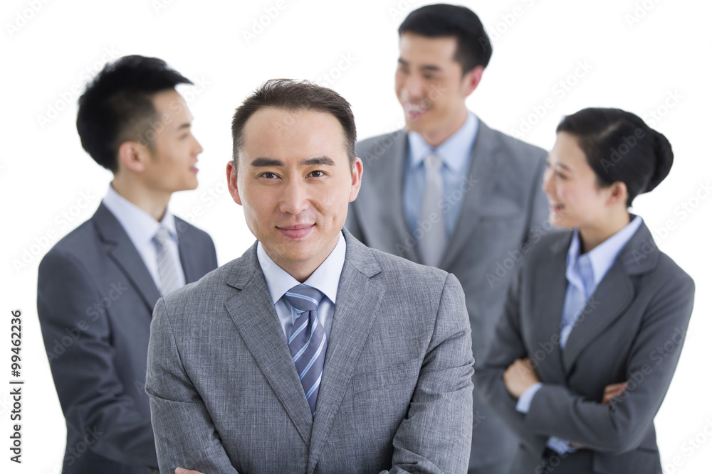 Businessman with team in background Businessman with team in background