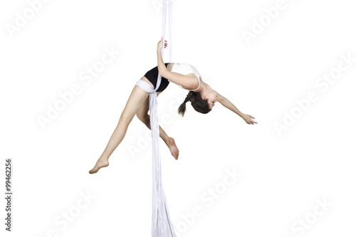 Athletic woman doing some tricks on silks