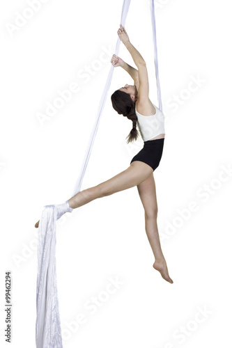 Athletic woman doing some tricks on silks