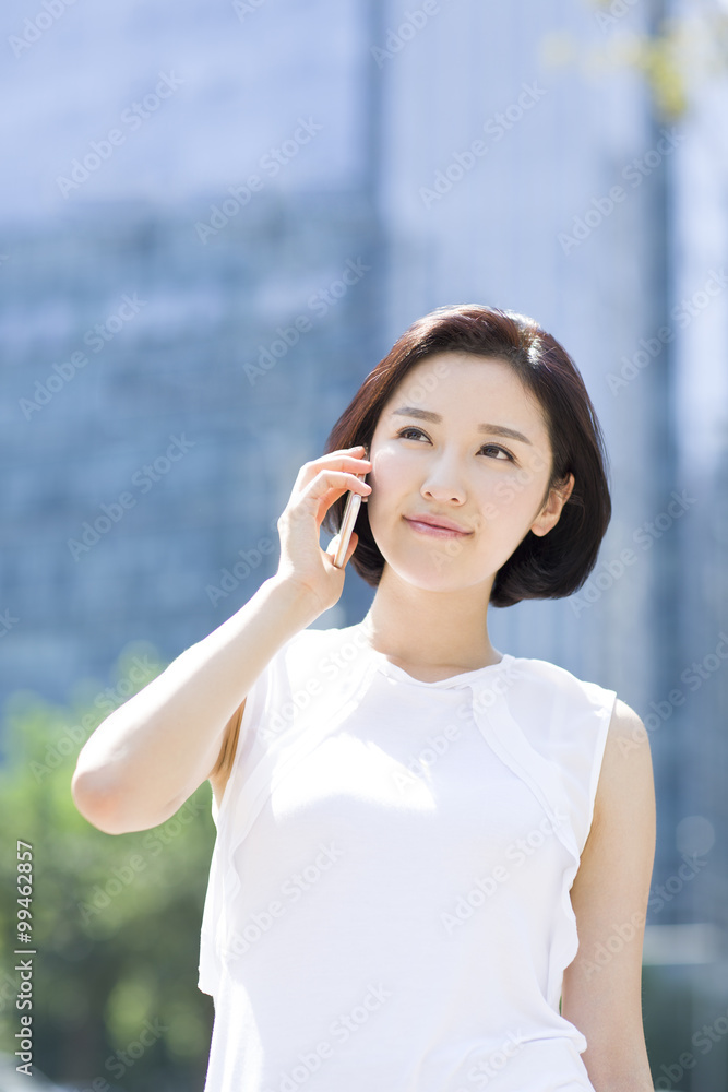 Happy young woman talking on the phone Happy young woman talking on the phone
