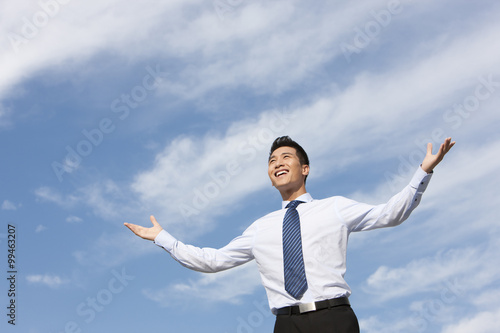 Businessman Standing with Arms Outstretched