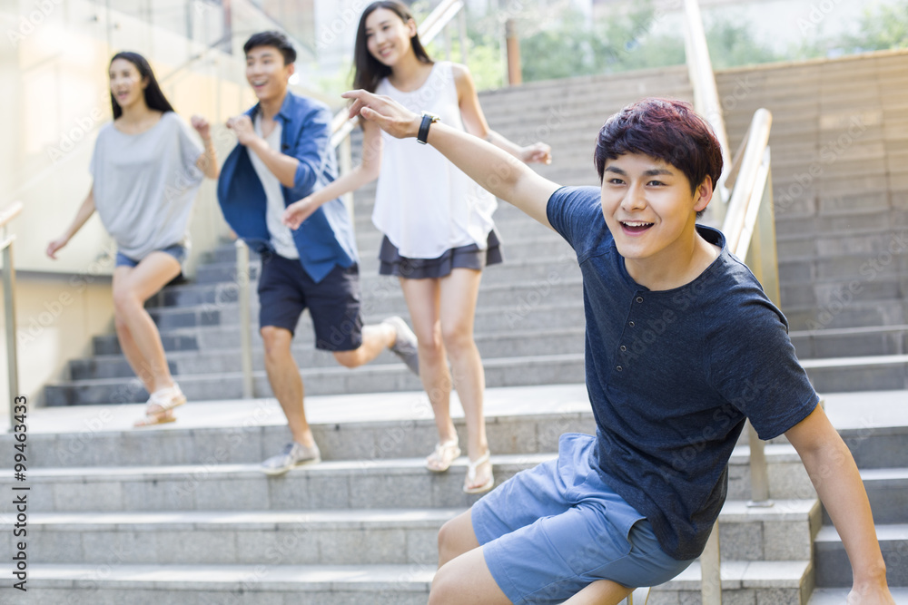 Obraz premium Young man sliding down banister on steps