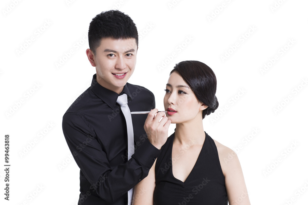Makeup artist applying make-up to young woman Makeup artist applying make-up to young woman
