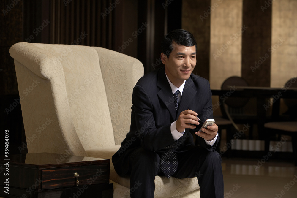 A business leader uses a PDA A business leader uses a PDA