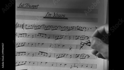 Close-up of hand with pen correcting music sheet photo