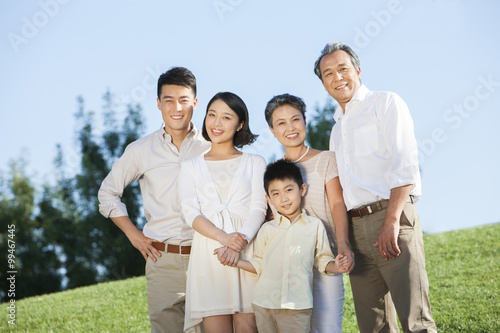 Portrait of big family smiling in a park