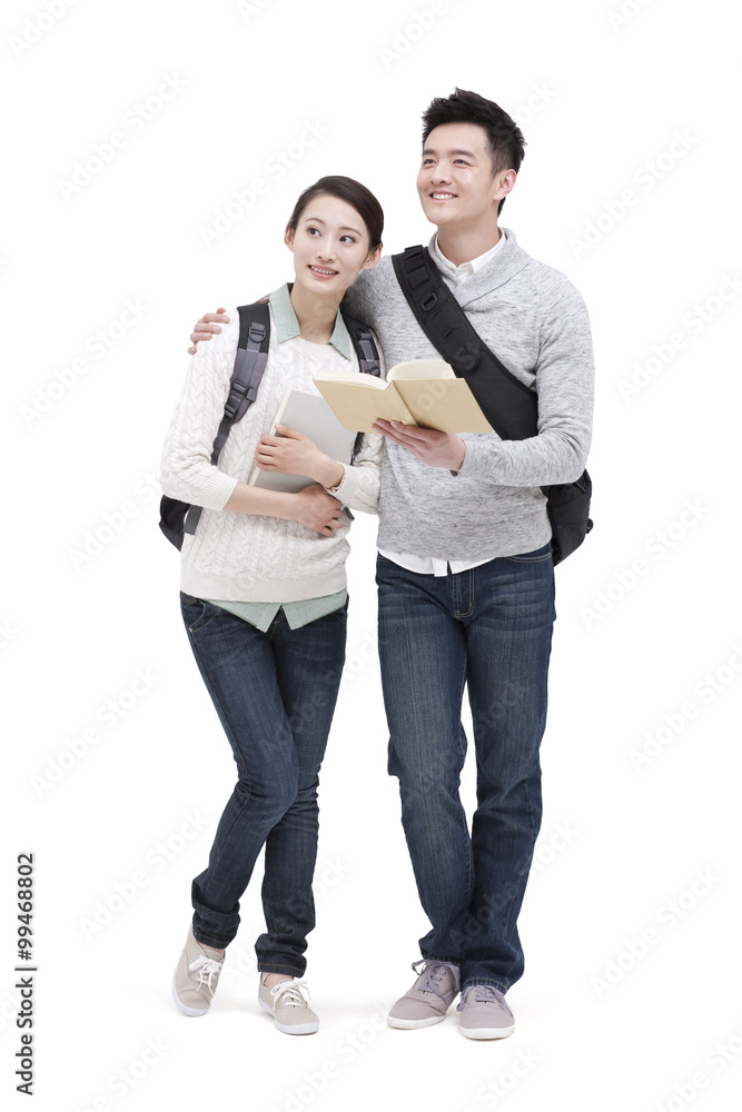 Fototapeta premium Cheerful college couple looking at view