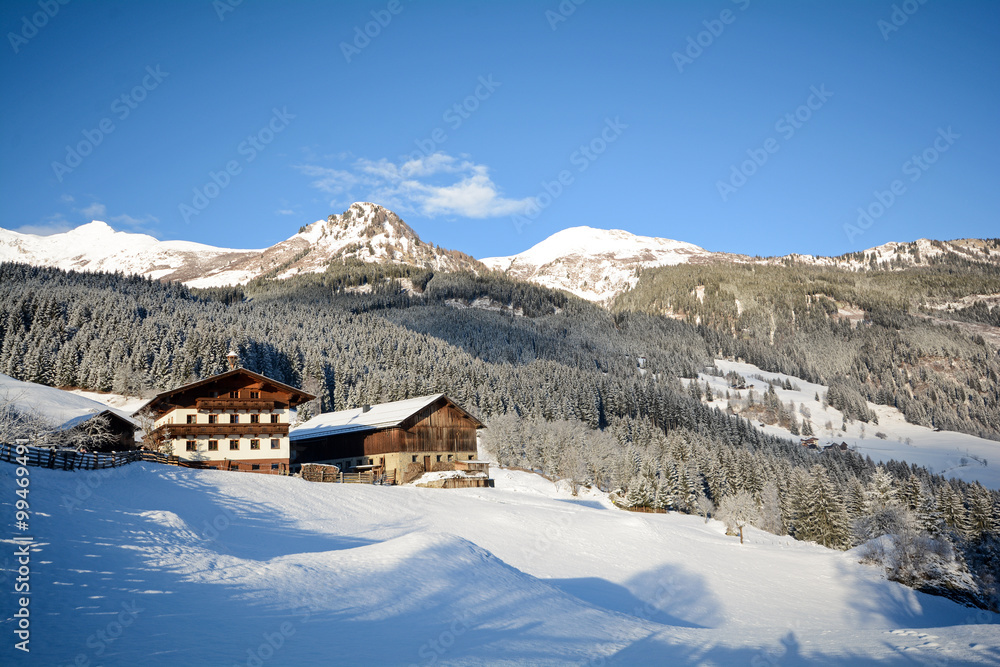 View to a winter landscape with old farmhouse and mountain range, Gasteinertal valley near Bad Gastein, Pongau Alps - Salzburg Austria Europe View to a winter landscape with old farmhouse and mountain range, Gasteinertal valley near Bad Gastein, Pongau Alps - Salzburg Austria Europe