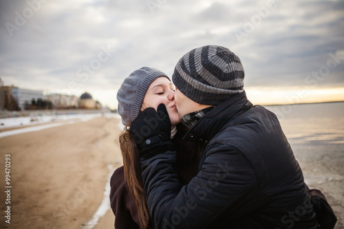 Portrait of happy young couple looking at camera in winter.