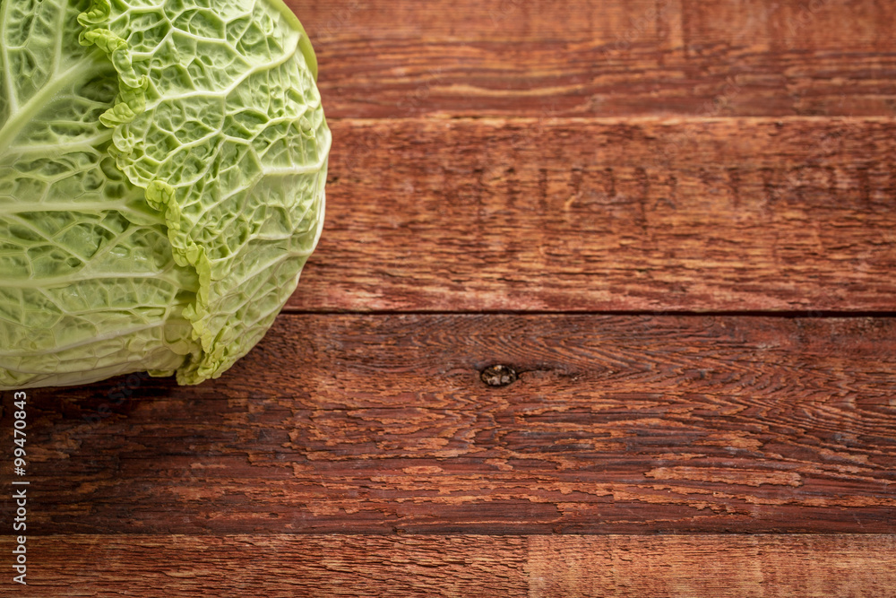 Fototapeta premium savoy cabbage on rustic wood