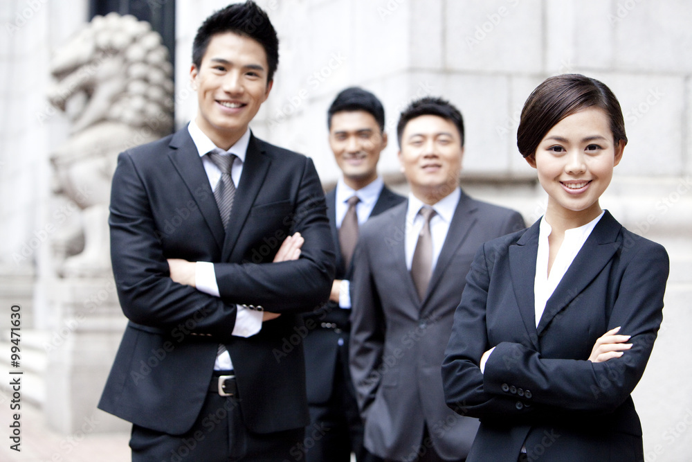 Portrait of confident business team outside a building, Hong Kong Portrait of confident business team outside a building, Hong Kong