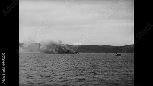Soldiers firing weapons from battleship, World War II