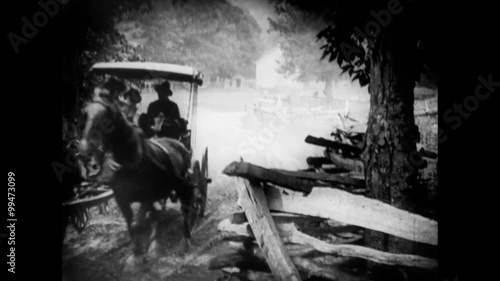 Wide shot of horse cart  traveling down country road, 1920s