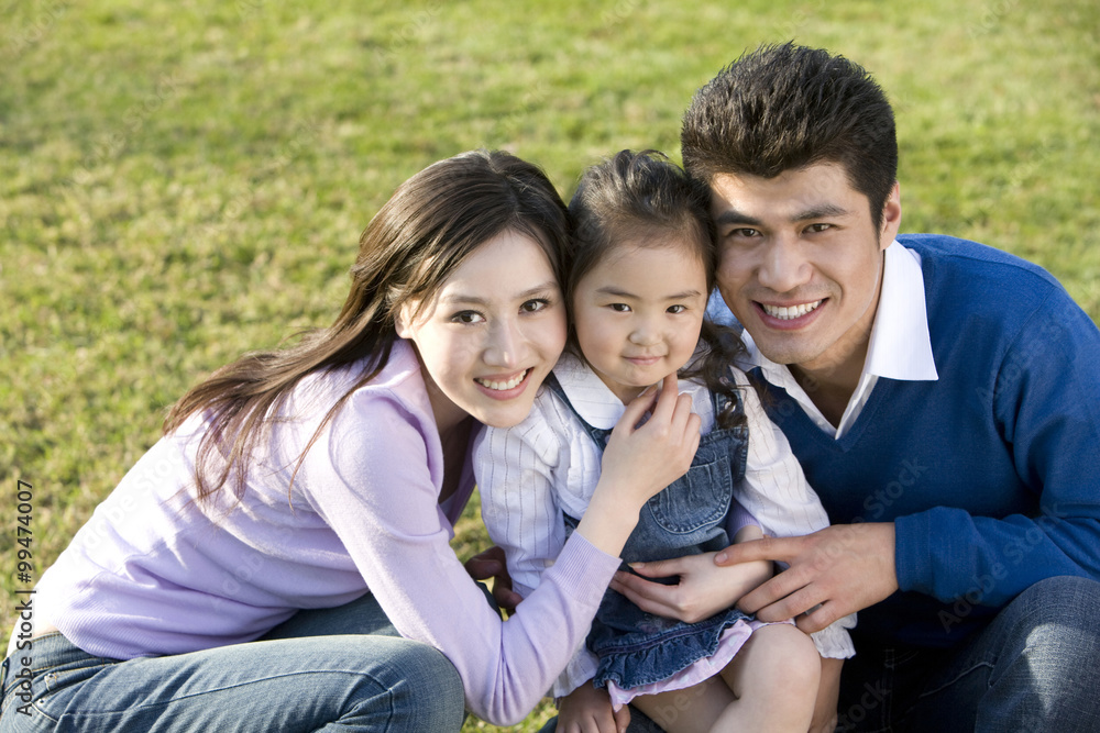 Fototapeta premium Portrait of young family at the park
